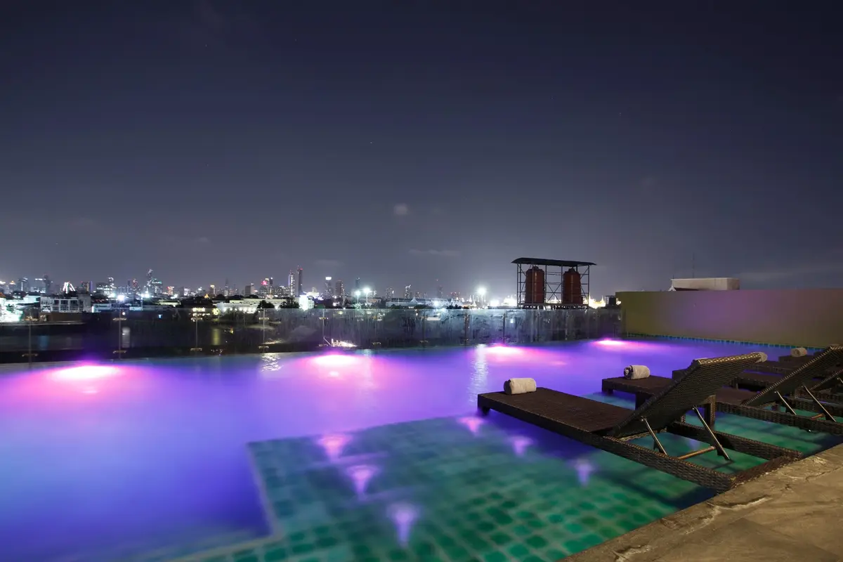 Illuminated rooftop pool at night